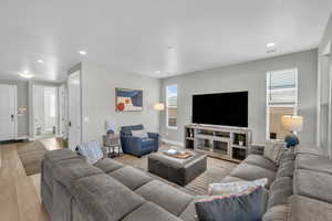 Living room with a healthy amount of sunlight and light wood-type flooring