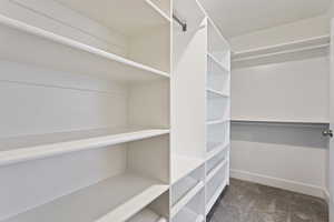 Walk in closet with dark carpet