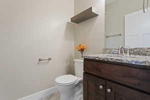 Bathroom featuring vanity and toilet