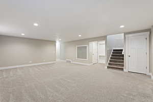 Basement with light colored carpet