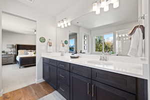 Bathroom with hardwood / wood-style flooring, vanity, and a shower with door