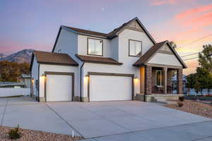 View of front of home featuring a mountain view and a garage