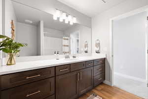 Bathroom with vanity, hardwood / wood-style floors, and curtained shower