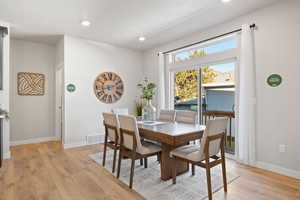 Dining space featuring light hardwood / wood-style flooring and a textured ceiling