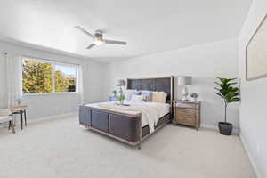 Carpeted bedroom with ceiling fan