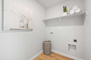 Washroom featuring hookup for a washing machine, wood-type flooring, and hookup for an electric dryer