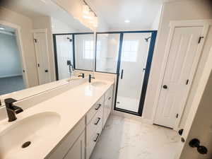 Primary on suite Bathroom featuring an enclosed shower and vanity