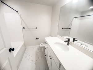 Full bathroom featuring vanity, toilet, and tub / shower combination