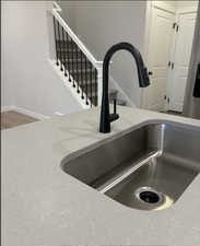 Interior details featuring light stone countertops and sink