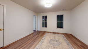 Empty room featuring hardwood / wood-style flooring