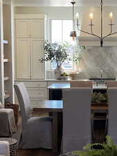 Kitchen with backsplash, decorative light fixtures, and a chandelier