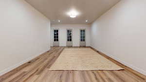 Empty room featuring wood-type flooring