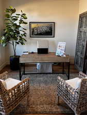 Office space with dark wood-type flooring