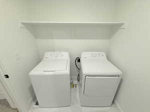 Indoor Laundry with washer, dryer, storage cabinets with folding area and sink