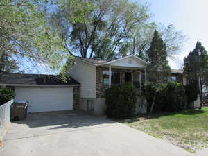 View of front of home featuring a garage and a front yard