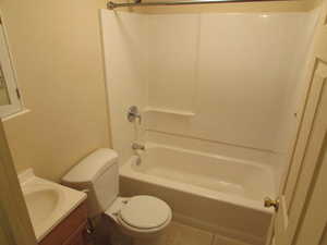 Full bathroom featuring tile patterned flooring, vanity, shower / bathtub combination, and toilet