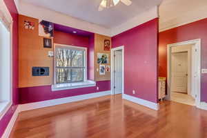 Spare room featuring ceiling fan and wood-type flooring