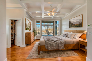 Bedroom featuring coffered ceiling, access to outside, ceiling fan, beam ceiling, and light hardwood / wood-style floors