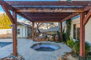 View of patio with cooling unit, an outdoor structure, an outdoor hot tub, and a pergola