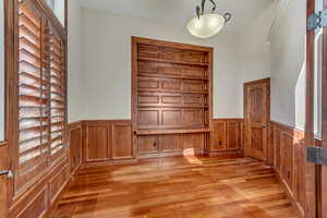 Interior space with built in shelves and light hardwood / wood-style flooring