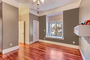 Unfurnished bedroom with hardwood / wood-style flooring and ceiling fan