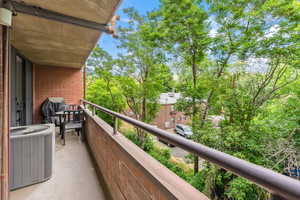 Balcony featuring central AC and area for grilling