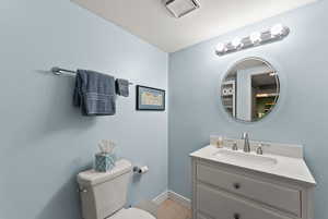 Bathroom featuring tile patterned flooring, vanity, and toilet