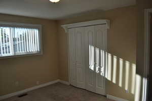 Unfurnished bedroom with a closet and carpet