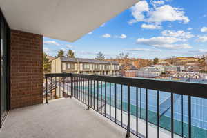 View of balcony and tennis court