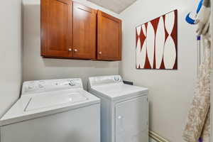 Clothes washing area with cabinets and washing machine and clothes dryer