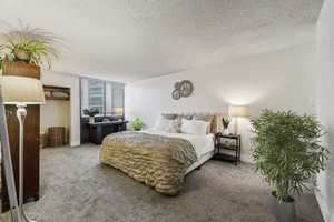 Bedroom with carpet floors and a textured ceiling