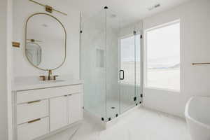 Bathroom with vanity and separate shower and tub