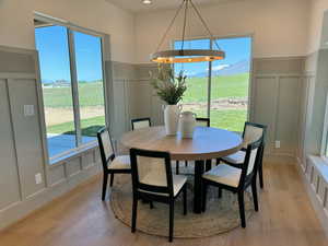 Dining area featuring plenty of natural light, a mountain view, and light hardwood / wood-style flooring