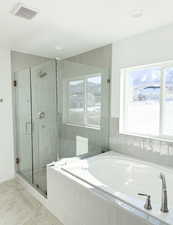 Bathroom featuring separate shower and tub