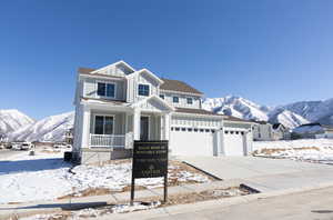 View of front of property with a mountain view and a garage