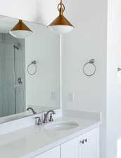 Bathroom with vanity and a tile shower