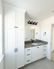 Bathroom with tile patterned flooring and vanity