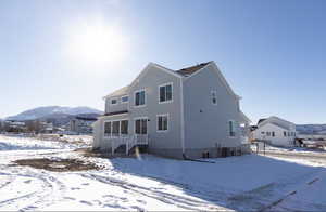 Snow covered house featuring a mountain view