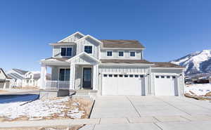 View of front facade featuring a mountain view, a garage, and covered porch