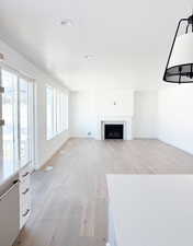 Unfurnished living room with light hardwood / wood-style floors and a textured ceiling