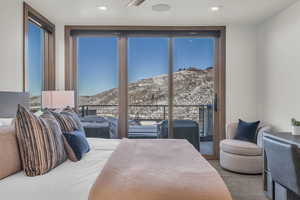 Bedroom with a mountain view and access to outside