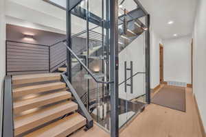 Stairs featuring hardwood / wood-style floors