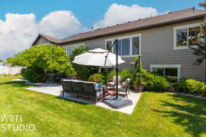 Rear view of house with an outdoor living space, a yard, and a patio area