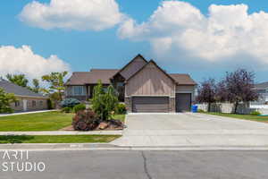 Craftsman-style home featuring a garage and a front yard