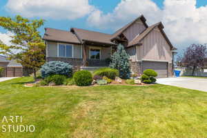 Craftsman inspired home with a garage, a front yard, and a porch