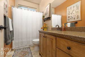 Bathroom featuring vanity, tile patterned floors, and toilet