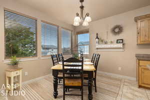 Tiled dining room with a notable chandelier