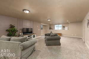 Carpeted living room featuring a textured ceiling