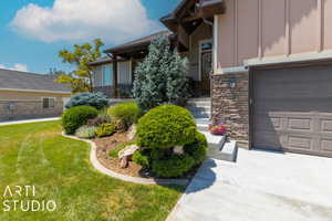 View of exterior entry with a lawn