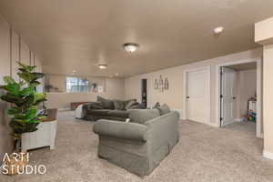 Living room featuring light carpet and a textured ceiling